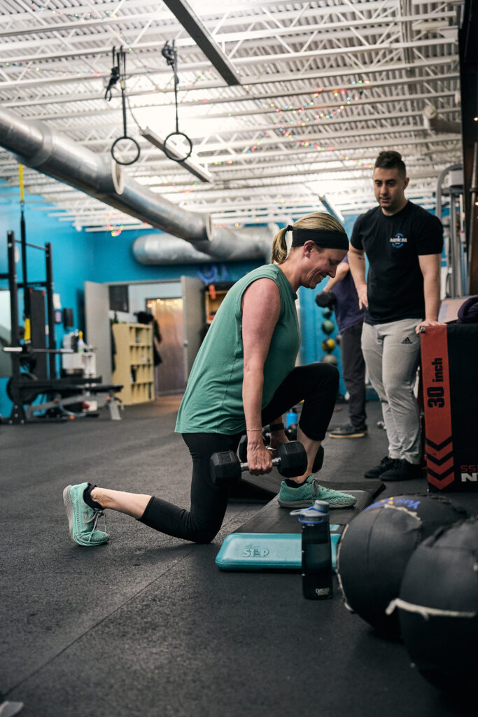 Dana performing lunges with trainer Nick